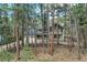 Two-story home with a two-car garage, charming front porch, and surrounded by beautiful trees at 17865 Smugglers Rd, Monument, CO 80132