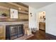 Rustic fireplace with reclaimed wood and brick hearth, alongside a charming wet bar at 17865 Smugglers Rd, Monument, CO 80132