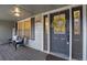 Charming front porch with seating, stylish door with wreath, and ample natural light at 17865 Smugglers Rd, Monument, CO 80132