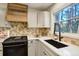 Bright kitchen with granite countertops, stainless steel appliances and a window with wooded views at 17865 Smugglers Rd, Monument, CO 80132
