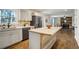 Open kitchen features a kitchen island, stainless steel refrigerator, and hardwood floors at 17865 Smugglers Rd, Monument, CO 80132