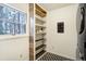 Bright laundry room with ample shelving, a modern washer/dryer, and patterned flooring at 17865 Smugglers Rd, Monument, CO 80132