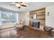 Bright living room features hardwood floors, a fireplace with rustic mantel, and scenic views at 17865 Smugglers Rd, Monument, CO 80132