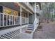 Inviting porch with white railings, outdoor seating, and hanging plants, showcasing a relaxing outdoor space at 17865 Smugglers Rd, Monument, CO 80132