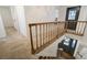 A well-lit staircase leading to the upper level of the home at 17865 Smugglers Rd, Monument, CO 80132