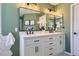 Stylish bathroom featuring double sinks, sleek fixtures, and an adjacent shower with tile surround at 2649 Westgate Ave, Highlands Ranch, CO 80126