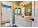 Modern bathroom featuring double vanity sinks, a bathtub shower combo, and sleek wood-look tile at 2649 Westgate Ave, Highlands Ranch, CO 80126