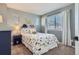 Cozy bedroom with dinosaur-themed decor, soft carpet, and natural light from two windows at 2649 Westgate Ave, Highlands Ranch, CO 80126