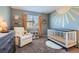 Adorable Bedroom with a sunny mural, neutral color scheme, and comfortable rocking chair at 2649 Westgate Ave, Highlands Ranch, CO 80126