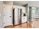 Bright kitchen with stainless steel refrigerator and hardware, as well as bright white cabinets at 2649 Westgate Ave, Highlands Ranch, CO 80126