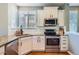 Granite countertops and stainless steel appliances accent this bright kitchen with a view outside at 2649 Westgate Ave, Highlands Ranch, CO 80126