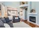 Inviting living room with a fireplace, hardwood floors, and views of the kitchen and dining areas at 2649 Westgate Ave, Highlands Ranch, CO 80126