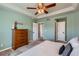 Spacious main bedroom with a wooden dresser and view of the closet and hallway entrances at 2649 Westgate Ave, Highlands Ranch, CO 80126