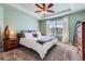 Bright main bedroom featuring a tray ceiling, plush carpet, and a large window with light curtains at 2649 Westgate Ave, Highlands Ranch, CO 80126