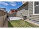 Backyard featuring a stone patio, green grass, and a wooden fence at 3429 Hardin St, Castle Rock, CO 80109