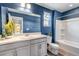 Bright bathroom with a vanity, toilet, and shower-tub combination with plank flooring at 3429 Hardin St, Castle Rock, CO 80109