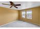 Bright bedroom with plush carpet, ceiling fan, and a view from the double windows at 3429 Hardin St, Castle Rock, CO 80109