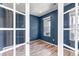 Serene bedroom with fresh blue walls, hardwood floors and natural light at 3429 Hardin St, Castle Rock, CO 80109