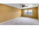 Spacious bedroom with neutral carpet, ceiling fan, and bright natural light from large double windows at 3429 Hardin St, Castle Rock, CO 80109