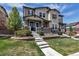 Charming two-story home features a welcoming front porch, stone accents, and well-manicured landscaping at 3429 Hardin St, Castle Rock, CO 80109