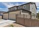 Modern exterior of a home with three car garage and wooden fence at 3429 Hardin St, Castle Rock, CO 80109
