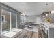 Bright living space features sleek, open-concept design, modern lighting, and beautiful wood floors at 3429 Hardin St, Castle Rock, CO 80109