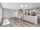 Bright living space features sleek, open-concept design, modern lighting, and beautiful wood floors at 3429 Hardin St, Castle Rock, CO 80109