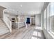 Bright, open-concept living area boasts sleek hardwood floors and flows into a modern kitchen at 3429 Hardin St, Castle Rock, CO 80109