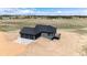 Aerial view of the home, showcasing its modern exterior, three-car garage, and spacious backyard at 37094 Still Rock Pt, Elizabeth, CO 80107