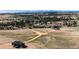 Scenic aerial view of the home nestled among trees with a sprawling landscape and distant mountains at 37094 Still Rock Pt, Elizabeth, CO 80107