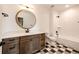 Bright bathroom featuring checkered floors, modern fixtures, and a bathtub with white subway tile at 37094 Still Rock Pt, Elizabeth, CO 80107