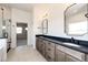 Elegant bathroom featuring double sinks, a sleek shower, and modern lighting fixtures at 37094 Still Rock Pt, Elizabeth, CO 80107