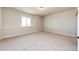 Carpeted bedroom with a window and a modern light fixture with neutral colored walls at 37094 Still Rock Pt, Elizabeth, CO 80107