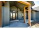 Front porch featuring wood beams, a modern door and stylish exterior at 37094 Still Rock Pt, Elizabeth, CO 80107