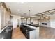 Open kitchen boasts stainless appliances, large island with stone countertop and hardwood floors at 37094 Still Rock Pt, Elizabeth, CO 80107
