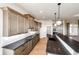 Open kitchen featuring a large island, stainless steel appliances, and quartz countertops with natural light at 37094 Still Rock Pt, Elizabeth, CO 80107