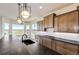 Modern kitchen featuring wood cabinets, granite countertops and oversized windows for amazing views at 37094 Still Rock Pt, Elizabeth, CO 80107