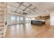 Open-concept living room featuring a stone fireplace and access to the kitchen with a large island at 37094 Still Rock Pt, Elizabeth, CO 80107