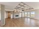 Bright living room with hardwood floors, a stone fireplace, decorative ceiling, and natural light at 37094 Still Rock Pt, Elizabeth, CO 80107