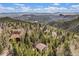 Mountain homes nestled amongst dense trees with panoramic views of distant mountain ranges at 11557 Green Cir, Conifer, CO 80433