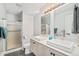 Bright bathroom featuring a double sink vanity, modern fixtures, and a glass-enclosed shower at 11557 Green Cir, Conifer, CO 80433