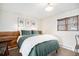 Serene bedroom featuring cozy bed, wooden headboard, and scenic window at 11557 Green Cir, Conifer, CO 80433