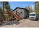 Charming home featuring a wooden deck, staircase, and ample parking space near natural surroundings at 11557 Green Cir, Conifer, CO 80433