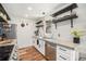 Well-appointed kitchen featuring stainless steel appliances, floating shelves, and sleek countertops at 11557 Green Cir, Conifer, CO 80433
