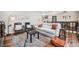 Cozy living room with comfortable seating, a vibrant rug, and natural light at 11557 Green Cir, Conifer, CO 80433