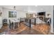 Open-concept living space showcasing wooden floors, fireplace, and view to the outdoors at 11557 Green Cir, Conifer, CO 80433