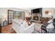 Inviting living room featuring a stone fireplace, wood accents, and a balcony view at 11557 Green Cir, Conifer, CO 80433