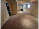 Spacious basement living area featuring a wood-burning stove, neutral carpet and ample lighting for a functional space at 3735 S Lewiston St, Aurora, CO 80013