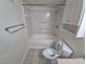 Bright bathroom featuring a tub and shower combination and tiled floors at 3735 S Lewiston St, Aurora, CO 80013