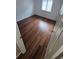 Bright bedroom features wood flooring, a window, and neutral paint, creating a serene and inviting space at 3735 S Lewiston St, Aurora, CO 80013